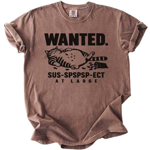 Brown t-shirt with black text "WANTED. SUS-SPSPSP-ECT AT LARGE" and a cat graphic.