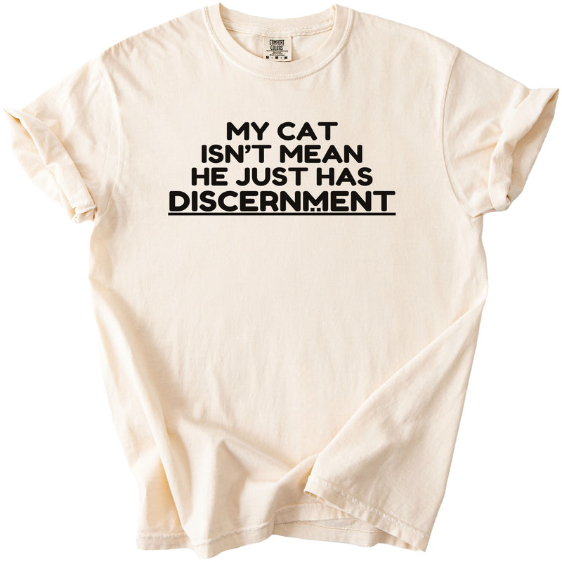 Cream t-shirt with black text: My Cat Isn't Mean He Just Has Discernment
