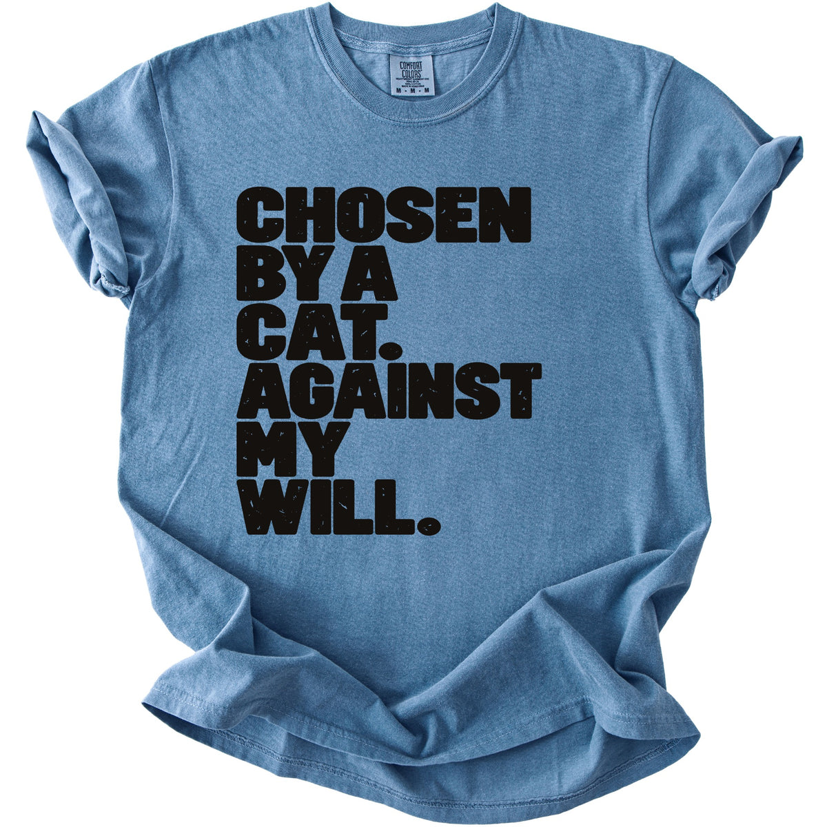 Blue t-shirt with black text reading "Chosen by a cat. Against my will."