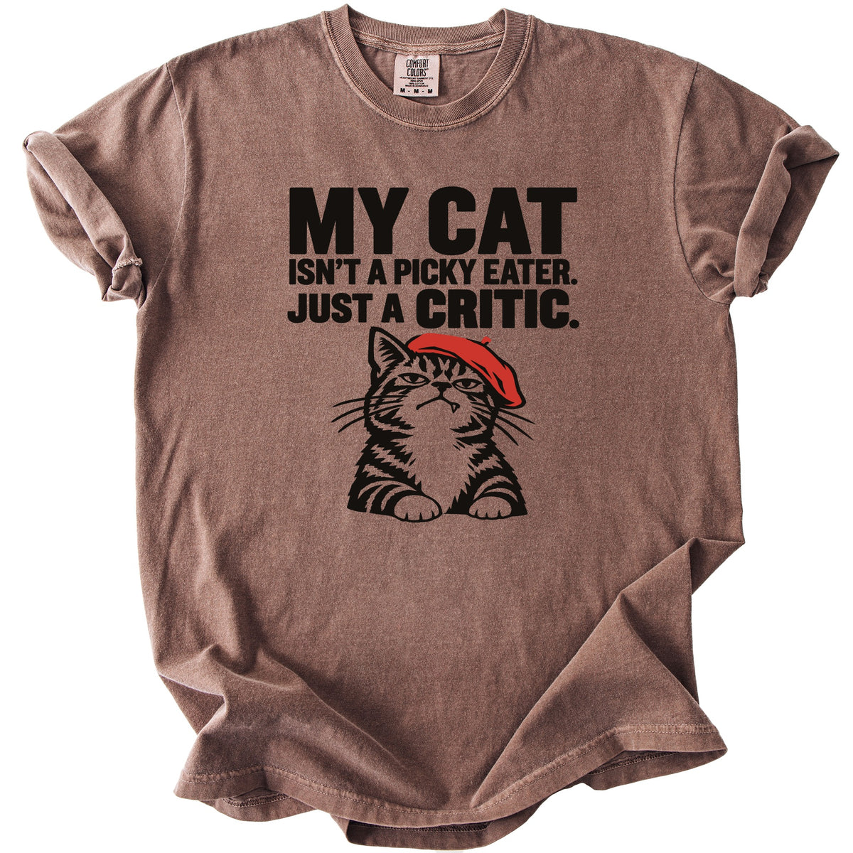 Brown t-shirt with black text and a cartoon cat wearing a red beret.