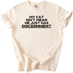Cream t-shirt with black text "MY CAT ISN'T MEAN HE JUST HAS DISCERNMENT".