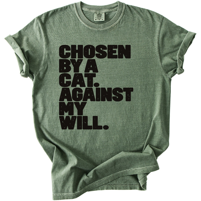 Green t-shirt with black text that reads "CHOSEN BY A CAT. AGAINST MY WILL."