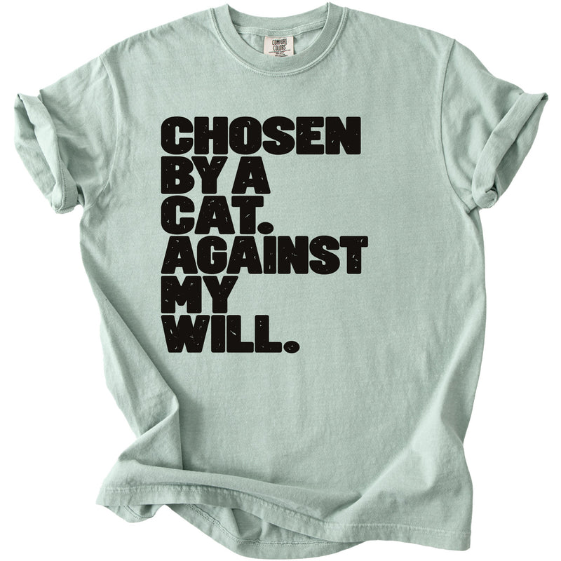 Light green t-shirt with black text "CHOSEN BY A CAT. AGAINST MY WILL."
