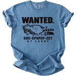 Blue t-shirt with black text "WANTED." and a striped cat, "SUS-SPSPSP-ECT AT LARGE".