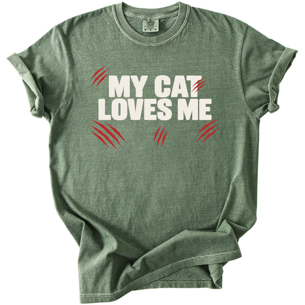 Green t-shirt with "MY CAT LOVES ME" in white text and red scratch marks.