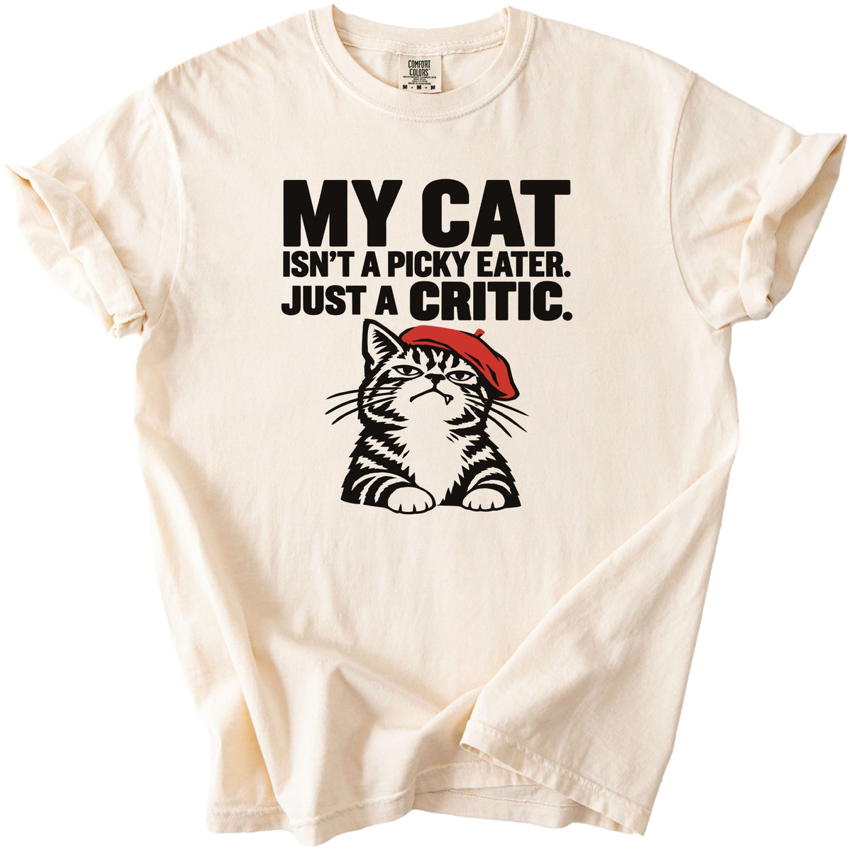 Cream t-shirt with black text "MY CAT ISN'T A PICKY EATER. JUST A CRITIC." and a cat graphic.
