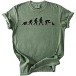 Green t-shirt with black graphic of human evolution ending with a person petting a cat.