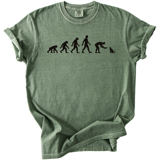 Green t-shirt with black graphic of human evolution ending with a person petting a cat.