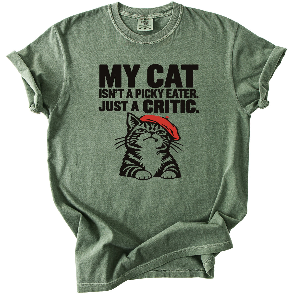 Green t-shirt with black text "MY CAT ISN'T A PICKY EATER. JUST A CRITIC." and a cat graphic.