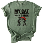 Green t-shirt with black text "MY CAT ISN'T A PICKY EATER. JUST A CRITIC." and a cat graphic.