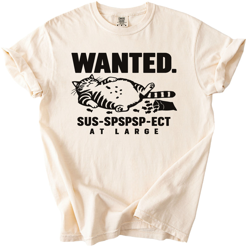 Cream t-shirt with black print: "WANTED. SUS-SPSPSP-ECT AT LARGE" and a cat.