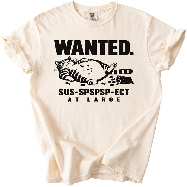 Cream t-shirt with "WANTED. SUS-SPSPSP-ECT AT LARGE" text and a cat graphic.