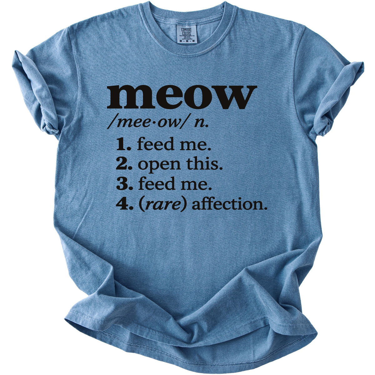 Blue t-shirt with black text defining "meow" as "feed me" and other phrases.