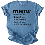 Blue t-shirt with black text defining "meow" as "feed me" and other phrases.