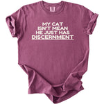 Maroon t-shirt with white text "MY CAT ISN'T MEAN HE JUST HAS DISCERNMENT".