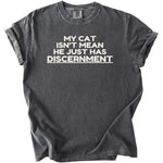 Dark grey t-shirt with white text reading "MY CAT ISN'T MEAN HE JUST HAS DISCERNMENT"